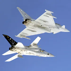 A Typhoon F2 fighter aircraft (top) from 11 Squadron, RAF Coningsby in close formation A Typhoon F2 fighter aircraft (top) from 11 Squadron, RAF Coningsby in close formation
