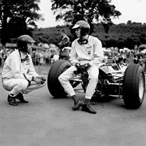 Images Dated 23rd August 2012: 1964 Belgian Grand Prix - Dan Gurney and Jim Clark: Jim Clark talks to Dan Gurney
