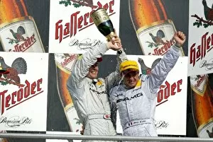 Images Dated 5th October 2003: DTM: Podium, Marcel Fassler, AMG-Mercedes, gives race winner Jean Alesi
