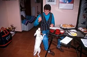 Images Dated 3rd August 2001: Formula One Drivers at Home Feature: Jarno Trulli at home teasing his pet dog as dinner is about