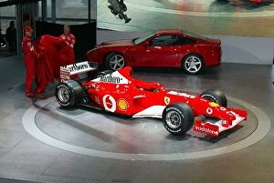 Images Dated 6th February 2002: Formula One Launch: The new Ferrari F2002 is unveiled by Michael Schumacher, left