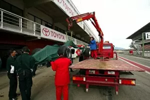 Images Dated 18th January 2004: Formula One Launch: The new Jaguar R5 is brought back to the pits on the back of the circuit truck