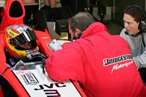 Images Dated 11th December 2005: Formula One Testing: Tiago Monteiro MF1 Racing chats to a Bridgestone engineer