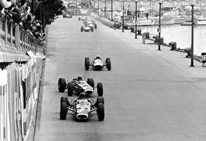 Monaco Collection: Formula One World Championship: Lap 1: Winner Graham Hill BRM P261 leads a sideways Jackie Stewart
