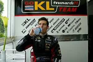 Images Dated 23rd May 2002: Formula One World Championship: Minardi driver Mark Webber has a refreshing drink