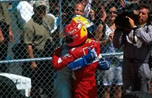 Formula One World Championship: Race winner Ralf Schumacher Williams is hugged by his brother Michael Ferrari