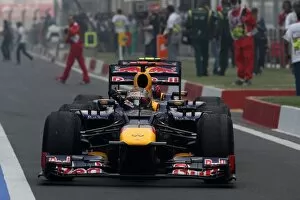 Formula One World Championship: Race winner Sebastian Vettel Red Bull Racing RB8 arrives in parc ferme pushed by Mark