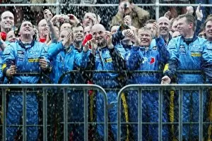 Images Dated 7th March 2004: Formula One World Championship: The Renault team are soaked in champagne by third placed Fernando