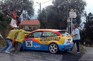 Images Dated 30th October 2003: World Rally Championship: Alistair Ginley, Ford Focus, is pushed by the marshals after his car