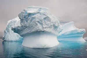 Abstract shaped icebergs with blue shadows in the Southern Ocean at Cierva Cove, Antarctica Abstract shaped icebergs with blue shadows in the Southern Ocean at Cierva Cove, Antarctica