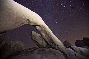 Arch Rock under a starry night sky, Joshua Tree National Park, California, USA