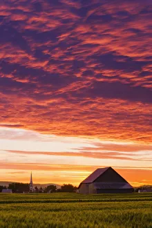 Barley Fields, Barn, Church And Colourful Sky At Dusk, Bas-Saint-Laurent Region, Saint-Donat, Quebec Barley Fields, Barn, Church And Colourful Sky At Dusk, Bas-Saint-Laurent Region, Saint-Donat, Quebec