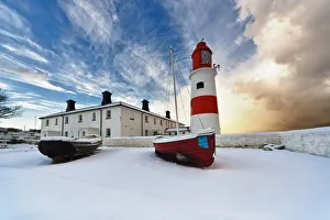 Boats Sitting On A Frozen Surface With A Lighthouse And Building In The Background; South Shields, Tyne And Wear Boats Sitting On A Frozen Surface With A Lighthouse And Building In The Background; South Shields, Tyne And Wear
