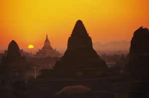 Burma (Myanmar), Bagan, Shwesandaw Paya, Temples Silhouetted Against Orange Sunset Burma (Myanmar), Bagan, Shwesandaw Paya, Temples Silhouetted Against Orange Sunset