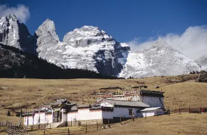 China, Jade Dragon Snow Mountain in background; Lijiang, Old buddhist temple on Yak China, Jade Dragon Snow Mountain in background; Lijiang, Old buddhist temple on Yak