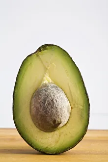 Close Up Of An Avocado Standing Upright Cut In Half With The Pit; Calgary, Alberta, Canada Close Up Of An Avocado Standing Upright Cut In Half With The Pit; Calgary, Alberta, Canada