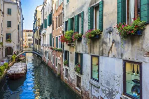 Close-up of buildings with windowboxes lining a canal in early morning in Venice, Italy Close-up of buildings with windowboxes lining a canal in early morning in Venice, Italy
