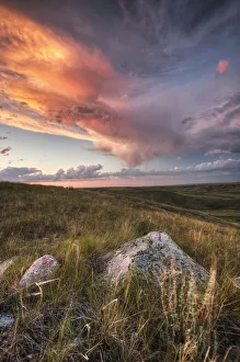 Clouds Lit At Sunset With Some Glacial Erratics Lying In Grasslands National Park; Saskatchewan Canada Clouds Lit At Sunset With Some Glacial Erratics Lying In Grasslands National Park; Saskatchewan Canada