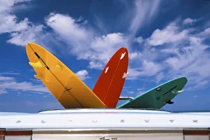 Colorful Surfboards In Vintage Plymouth Fury Iii Car, Puffy Clouds In Background Colorful Surfboards In Vintage Plymouth Fury Iii Car, Puffy Clouds In Background