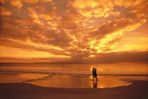 Images Dated 22nd February 1999: Couple Silhouetted On The Beach During Sunset, Fiery Orange Sky, Clouds