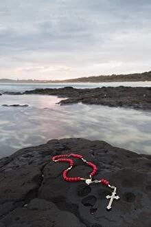 Images Dated 2nd January 2010: A Cross And Rosary Beads Laying On A Rock At Flat Rock; Ballina, New South Wales, Australia