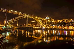 Dom Luis I Bridge crossing River Douro with Vila Nova de Gaia lit up at night, Porto, Portugal