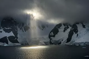 Nature and Landscapes Gallery: Early morning sun breaking through cloud cover in Antarcticas Lemaire Channel