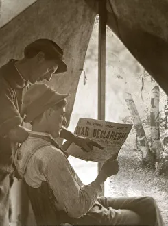 Two farmers looking at the Toronto Sunday News with headline War Declared, April 1917; Ontario, Canada Two farmers looking at the Toronto Sunday News with headline War Declared, April 1917; Ontario, Canada