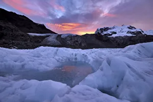 Frozen pool of water on the ice of the Gorner Glacier at sunrise Frozen pool of water on the ice of the Gorner Glacier at sunrise