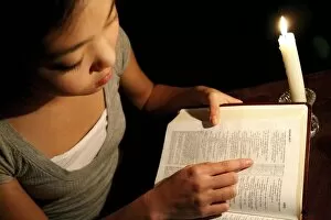 Images Dated 20th March 2008: Girl Reading The Bible By Candlelight