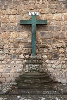 A Green Cross Against A Stone Wall Of Plaza De Armas; Cusco Peru A Green Cross Against A Stone Wall Of Plaza De Armas; Cusco Peru