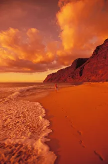 Hawaii, Kauai, Polihale State Park Beach At Sunset, Back View Of Woman Walking Along The Shoreline Hawaii, Kauai, Polihale State Park Beach At Sunset, Back View Of Woman Walking Along The Shoreline