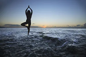 Hawaii, Oahu, Fit Young Girl On The Beach Doing Yoga On The Rocky Coastline Hawaii, Oahu, Fit Young Girl On The Beach Doing Yoga On The Rocky Coastline