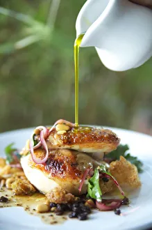 Hawaii, Olive Oil Being Poured Over Delicious Chicken Dish Hawaii, Olive Oil Being Poured Over Delicious Chicken Dish