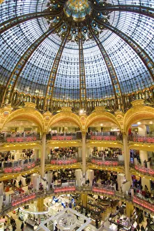 High View Of The Domed Central Area Of Galeries Lafayette, Looking Down On Shoppers, Paris, France High View Of The Domed Central Area Of Galeries Lafayette, Looking Down On Shoppers, Paris, France