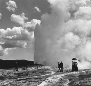 Historic image in black and white of tourists at Old Faithful geyser, Yellowstone National Park, circa 1900; Wyoming Historic image in black and white of tourists at Old Faithful geyser, Yellowstone National Park, circa 1900; Wyoming