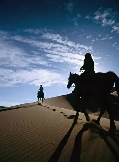 Images Dated 27th March 2006: Horseback Riders In Silhouette On Sand Dune