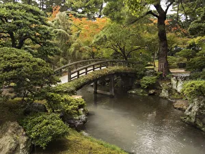 Japanese Stone Bridge Across A Stream In A Park; Kyoto, Japan Japanese Stone Bridge Across A Stream In A Park; Kyoto, Japan