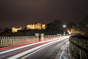 Light Trails On A Road And Illuminated Building In The Background At Nighttime; Alnwick Light Trails On A Road And Illuminated Building In The Background At Nighttime; Alnwick