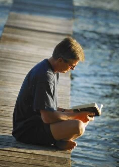 Images Dated 19th July 2005: Man Reading His Book By The Waters Edge