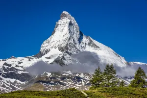 The Matterhorn with grey mountain clouds on a sunny day at Zermatt, Switzerland The Matterhorn with grey mountain clouds on a sunny day at Zermatt, Switzerland
