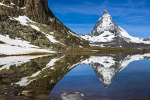 The Matterhorn reflected in Riffelsee Lake on a sunny day at Zermatt, Switzerland The Matterhorn reflected in Riffelsee Lake on a sunny day at Zermatt, Switzerland