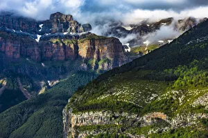Mondarruego mountain with mist and overview of the Pyrenees in Ordesa y Monte Perdido National Park in Huesca Province Mondarruego mountain with mist and overview of the Pyrenees in Ordesa y Monte Perdido National Park in Huesca Province