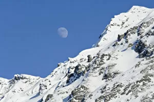Images Dated 11th March 2006: Moon Rising Over Snow Covered Mountain Peak At Hatcher Pass In Southcentral Alaska