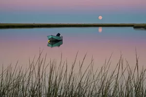High Res Gallery: Moonrise at sunset and a lone boat in Salt Pond Bay, Eastham, Cape Cod, Massachusetts