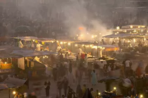 Images Dated 21st November 2009: Morocco, People and food stalls in Place Djemaa el Fna at dusk; Marrakesh