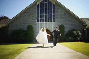 Images Dated 19th June 2004: Newlyweds Run Together From Chapel