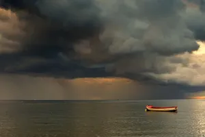 North Sea, Sunderland, Tyne And Wear, England; Dark Clouds And Lone Boat North Sea, Sunderland, Tyne And Wear, England; Dark Clouds And Lone Boat