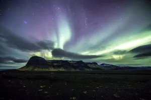 northern lights dance over a mountain range on Iceland's South Coast, Vik, Iceland northern lights dance over a mountain range on Iceland's South Coast, Vik, Iceland