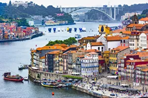 Overview of harbor and waterfront with the Arrabida Bridge in the background in Porto, Norte, Portugal Overview of harbor and waterfront with the Arrabida Bridge in the background in Porto, Norte, Portugal